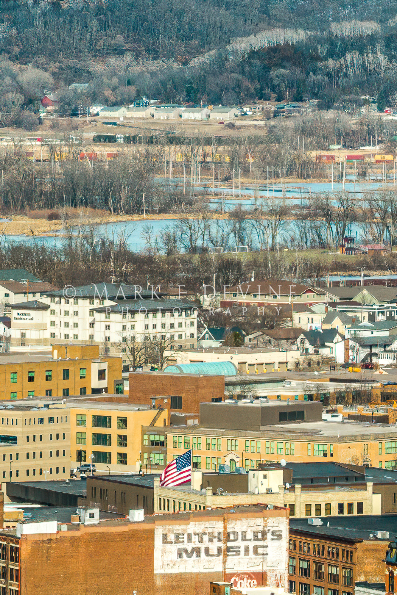 Crop from the actual full panorama. View is across downtown La Crosse northeast towards Highway 16. Bluffs in the distance are...