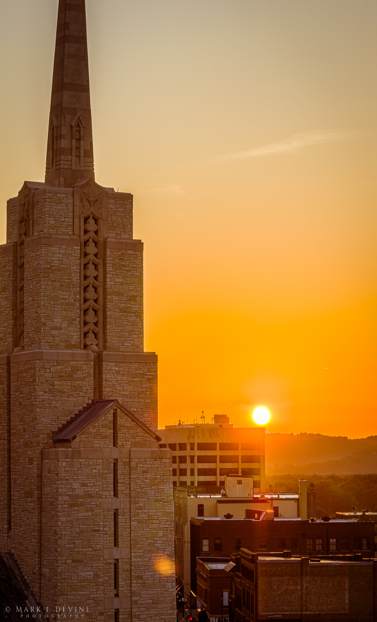 Aerial image of the spire of Saint Joseph the Workman Cathedral at sunset.